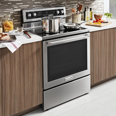 A pot and pan on the stovetop of a stainless steel KitchenAid® range